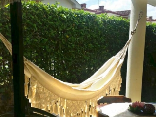 beige macrame hammock in patio